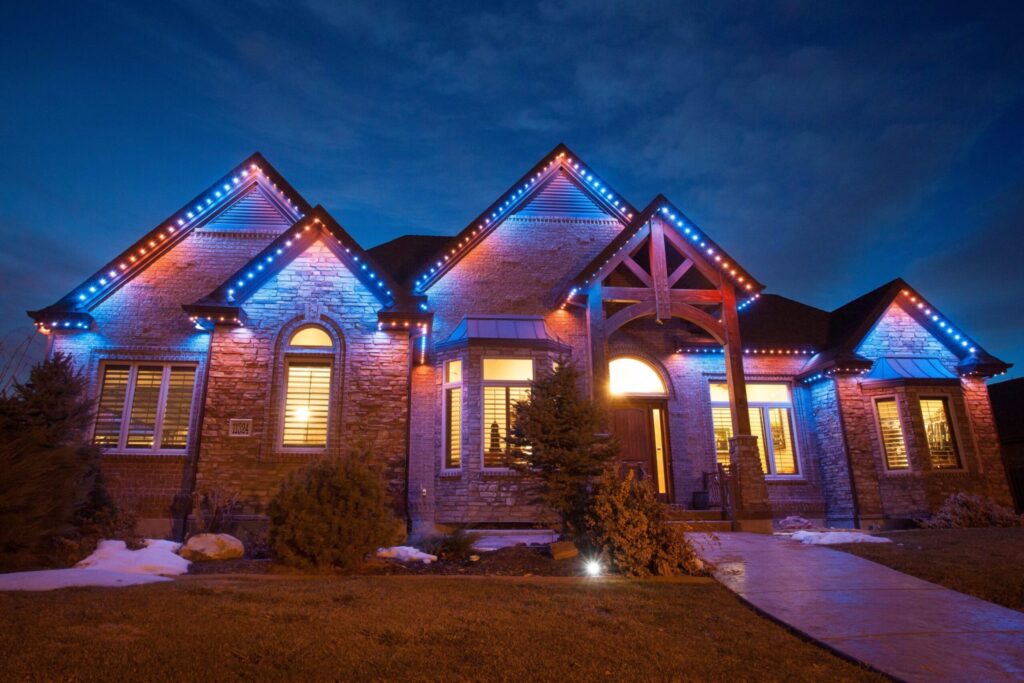 Brick house with blue and orange lighting from Jellyfish Outdoor Lighting System